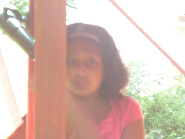 Maya scared away by a daddy long leg on the playset