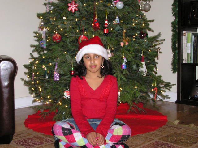 Maya looking sad at the tree with no gifts