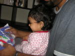 Kayla starts to open gift #2