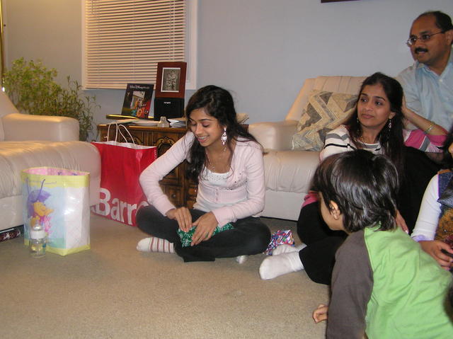 Amy opening up a gift from Kayla
