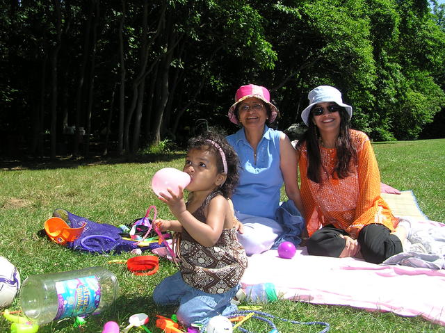 Mom, Kaki, and Kayla blowing up a balloon