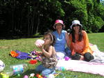 Mom, Kaki, and Kayla blowing up a balloon